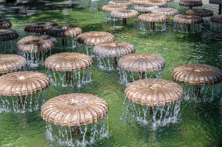 MUNCHEN, GERMANY - JULY 26, 2015: Water mushroom fountain on Frauenplatz in front of the Frauenkirche, Munich, Bavaria, Germany; designed in 1972 by Bernhard Winkler as a water bell fountainのeditorial素材