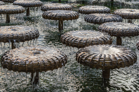 MUNCHEN, GERMANY - JULY 3, 2015: Water mushroom fountain on Frauenplatz in front of the Frauenkirche, Munich, Bavaria, Germany; designed in 1972 by Bernhard Winkler as a water bell fountainのeditorial素材