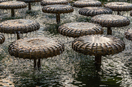 MUNCHEN, GERMANY - JULY 3, 2015: Water mushroom fountain on Frauenplatz in front of the Frauenkirche, Munich, Bavaria, Germany; designed in 1972 by Bernhard Winkler as a water bell fountainのeditorial素材