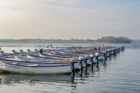 NORMANTON, UNITED KINGDOM - MARCH 20, 2015: Small wooden boats on Rutland Water, a reservoir in Rutland, England, UKのeditorial素材