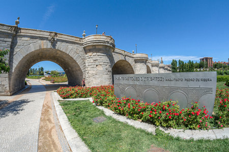 MADRID, SPAIN - AUGUST 23, 2015: Plaque marking the Toledo Bridge monument in Madrid, Spain, built between 1718-1732 in Churrigueresque Baroque style, by architect Pedro de Riberaのeditorial素材
