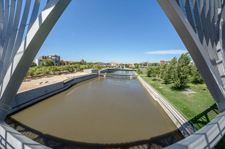 MADRID, SPAIN - AUGUST 23, 2015: View of the Manzanares River from the modern Monumental Arganzuela Bridge in Madrid, Spain, designed by French architect Dominique Perrault, inaugurated in 2011のeditorial素材