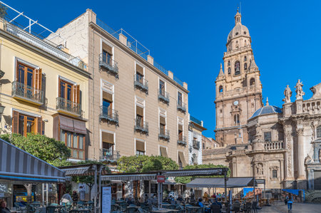 MURCIA, SPAIN - JANUARY 17, 2023: The Plaza del Cardenal Belluga, one of the most prominent urban spaces in the old town of Murcia, Spain, with the Cathedral Church of Saint Mary in the backgroundのeditorial素材