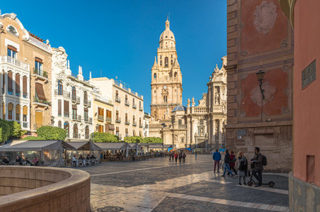 MURCIA, SPAIN - JANUARY 17, 2023: The Plaza del Cardenal Belluga, one of the most prominent urban spaces in the old town of Murcia, Spain, with the Cathedral Church of Saint Mary in the backgroundのeditorial素材
