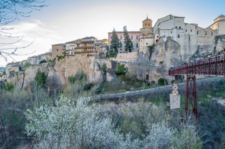 CUENCA, SPAIN - MARCH 28, 2015: People crossing the San Pablo Bridge, an iron and wood beam bridge spanning the Huecar River in Cuenca, Spain, opened in 1903のeditorial素材