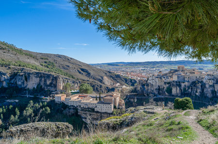 CUENCA, SPAIN - MARCH 28, 2015: Panoramic view of the Huecar Gorge with the town of Cuenca, Spain. In the foreground, the former Convent of San Pablo, since 1993 it houses a state-owned Parador hotelのeditorial素材