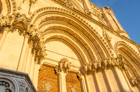 Dusk view of the Gothic Cathedral of Saint Mary and Saint Julian, with facade illuminated by warm light. It is a Catholic cathedral in the town of Cuenca, Castilla La Mancha, Spainの写真素材