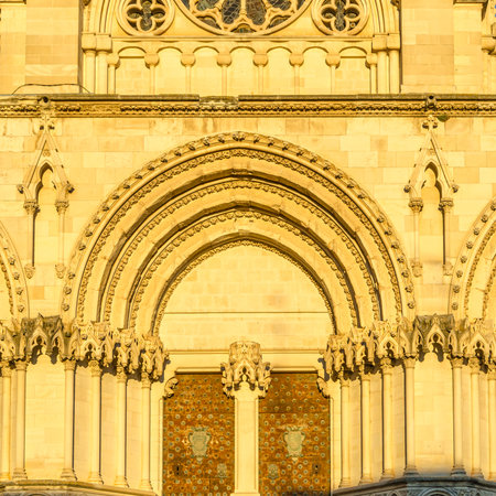Dusk view of the Gothic Cathedral of Saint Mary and Saint Julian, with facade illuminated by warm light. It is a Catholic cathedral in the town of Cuenca, Castilla La Mancha, Spainの写真素材