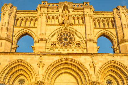 Dusk view of the Gothic Cathedral of Saint Mary and Saint Julian, with facade illuminated by warm light. It is a Catholic cathedral in the town of Cuenca, Castilla La Mancha, Spainの写真素材