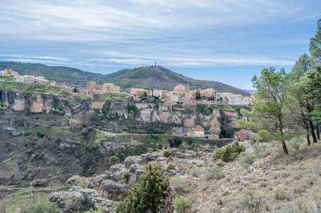 View of the Jucar Gorge and the town of Cuenca, Spain, a natural phenomenon caused by the erosion of the waters of this river on the limestone rock on which the city is built and which surrounds itの写真素材