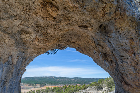 Devil's Window (Spanish: Ventano del Diablo), an example of karst erosion on limestone rock in the Serrania de Cuenca Natural Park, Castilla la Mancha, Spainの写真素材