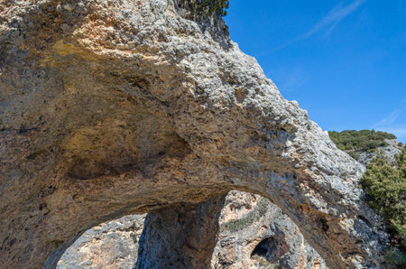 Devil's Window (Spanish: Ventano del Diablo), an example of karst erosion on limestone rock in the Serrania de Cuenca Natural Park, Castilla la Mancha, Spainの写真素材