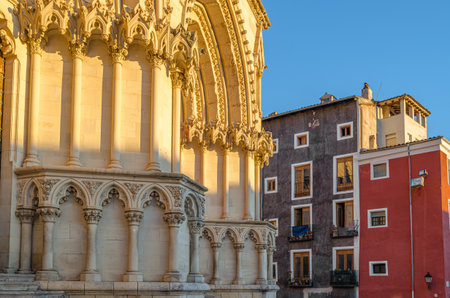 Dusk view of the Gothic Cathedral of Saint Mary and Saint Julian, with facade illuminated by warm light. It is a Catholic cathedral in the town of Cuenca, Castilla La Mancha, Spainの写真素材