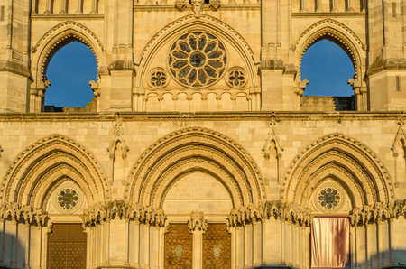 Dusk view of the Gothic Cathedral of Saint Mary and Saint Julian, with facade illuminated by warm light. It is a Catholic cathedral in the town of Cuenca, Castilla La Mancha, Spainの写真素材