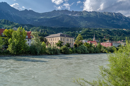 View of buildings with colorful facades on the banks of the Inn River in Innsbruck, Tyrol, Austriaの写真素材