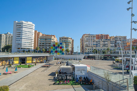 MALAGA, SPAIN - JANUARY 27, 2020: View of "Muelle Uno", an outdoor shopping area with modern shops and restaurants along the promenade in Malaga, Spain, with the Centre Pompidou Malaga in the backgroundのeditorial素材