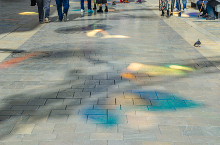 Colorful reflections on the pavement of a street, abstract backgroundの写真素材