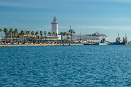 MALAGA, SPAIN - JANUARY 28, 2020: View of the port of Malaga, Spain, with its lighthouse and a cruise ship mooredのeditorial素材