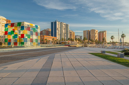 MALAGA, SPAIN - JANUARY 28, 2020: View of "Muelle Uno", an outdoor shopping area with modern shops and restaurants along the promenade in Malaga, Spain, with the Center Pompidou Malaga in the backgroundのeditorial素材