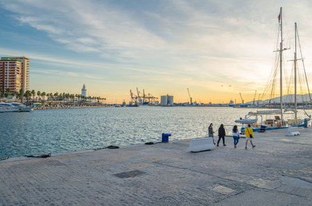 MALAGA, SPAIN - JANUARY 28, 2020: View of the port of Malaga, Spain, with its lighthouse and a cruise ship mooredのeditorial素材