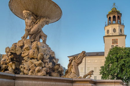 SALZBURG, AUSTRIA - JULY 5, 2015: Residenzbrunnen baroque fountain on Residenzplatz with the Salzburg Museum building in the background in the historic old town of Salzburg, Austriaのeditorial素材