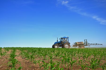 Tractor plowing the fields horizontalの写真素材