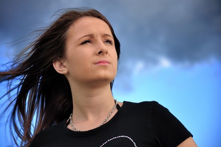 Wind in the hair and blue sky with cloudsの写真素材