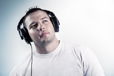 Young boy listening music in headphones isolatedの写真素材