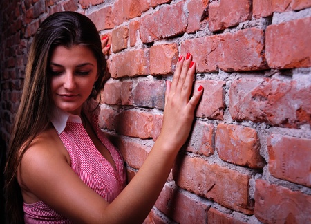Girl and a wall backgroundの写真素材