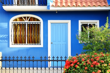 Outdoor image of a typical Dominican house with colorful flowerbed in front of itの写真素材