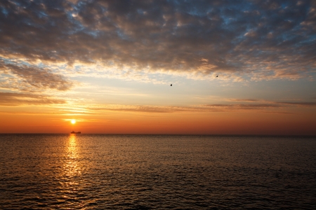 Beautiful sunrise over the horizon, dramatic cloudsの写真素材