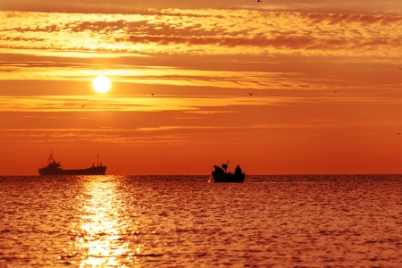 Beautiful sunrise over the horizon, dramatic cloudsの写真素材