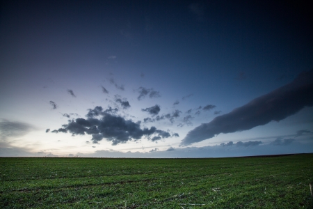 green field and darkk blue sky の写真素材