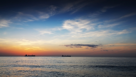 Beautiful sunset over the horizon, dramatic cloudsの写真素材