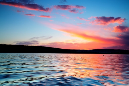 Beautiful sunset over the horizon, dramatic cloudsの写真素材