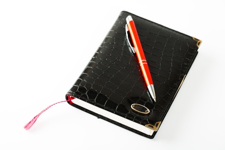 Notebook with pen isolated on white backgroundの写真素材