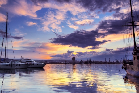 Scenic view of yachts and boat at dramatic sunset with cloudscape backgroundの写真素材