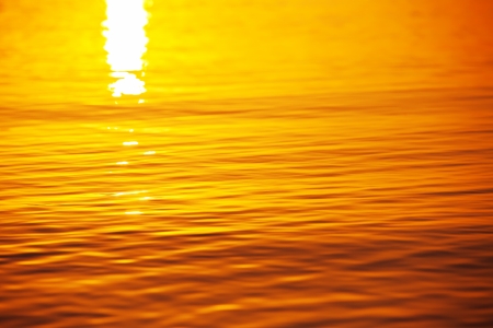 Golden wave texture and sun reflectingの写真素材