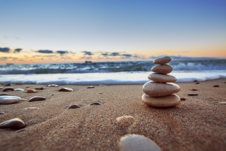 Stones balance on beach, sunrise shot