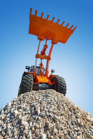 Excavator on the top and blue sky backgroundの写真素材