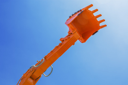 Excavator buckets ready to use isolated on blue skyの写真素材