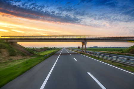 Car on the road with motion blur background, sunrise shotの写真素材