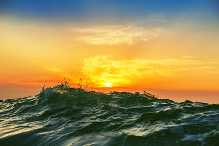 Sunrise light shining on ocean wave