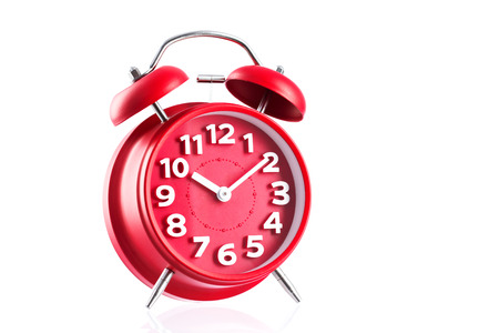 Vintage red alarm clock isolated on a white background