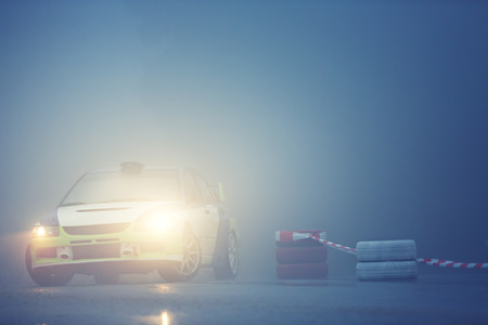 Car drives on rural road with fogの写真素材
