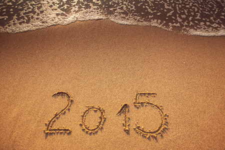 New year 2015 written in sandの写真素材
