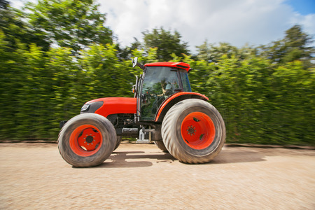 Man with tractor in a garden, blurred motion