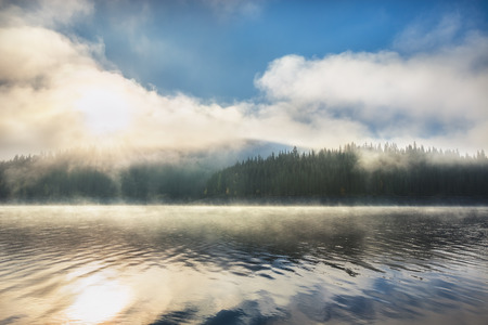 Morning fog on the lake, sunrise shotの写真素材
