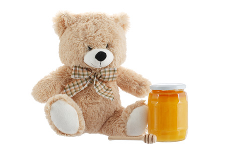 Toy teddy bear isolated on white background with honeyの写真素材