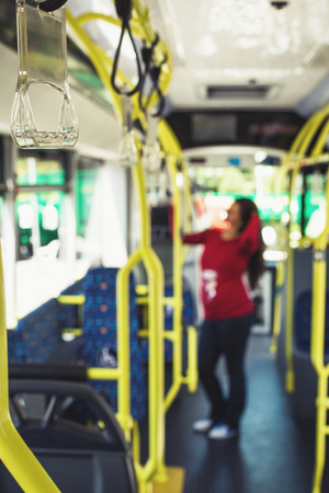 Silhouette of a young pregnant woman travelling with public transport toward work/ schoolの写真素材